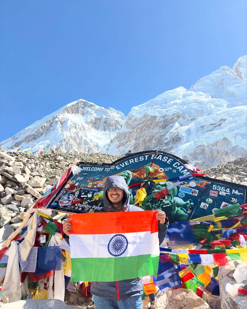 Ronak at Everest Base Camp holding the Indian flag