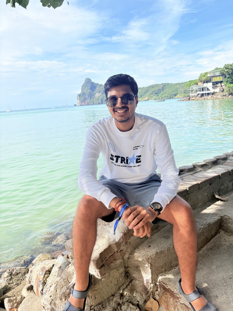 Ronak sitting by clear turquoise sea
