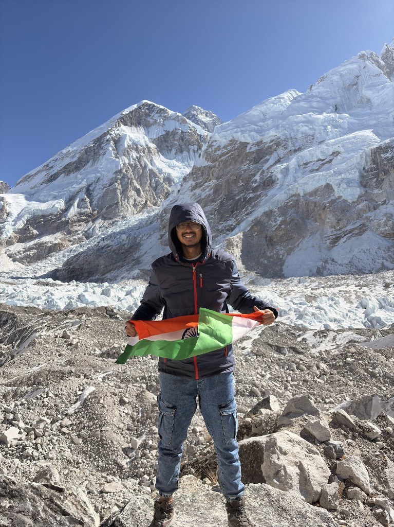 Ronak holding the Indian flag before Everest