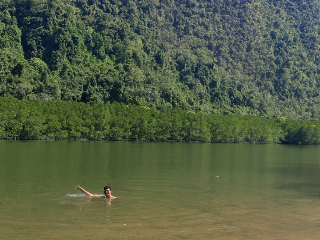 Ronak swimming in a lake surrounded by jungle