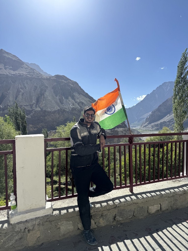 Ronak with the Indian flag in a Ladakh mountain valley